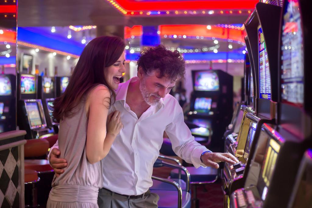 Majestic Elegance Punta Cana (Adults Only) Εξωτερικό φωτογραφία A couple playing a slot machine